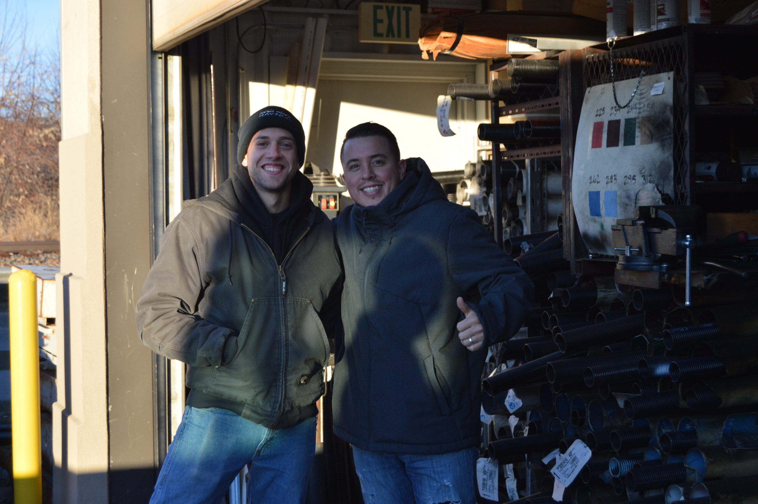 Photo of Two Smiling Garage Door Technicians from the Front Range Raynor Garage Door Team at their Fort Collins, Colorado Showroom